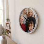 Custom photo wall clock with white frame displaying a family portrait