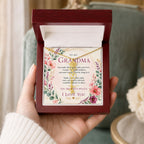 Gold birthflower name necklace with daffodil charm and script name on model