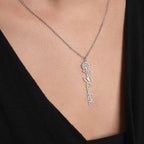 Gold birthflower name necklace with daffodil charm and script name on model