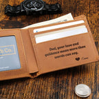 Open leather wallet with an engraved message beside a wristwatch and cash