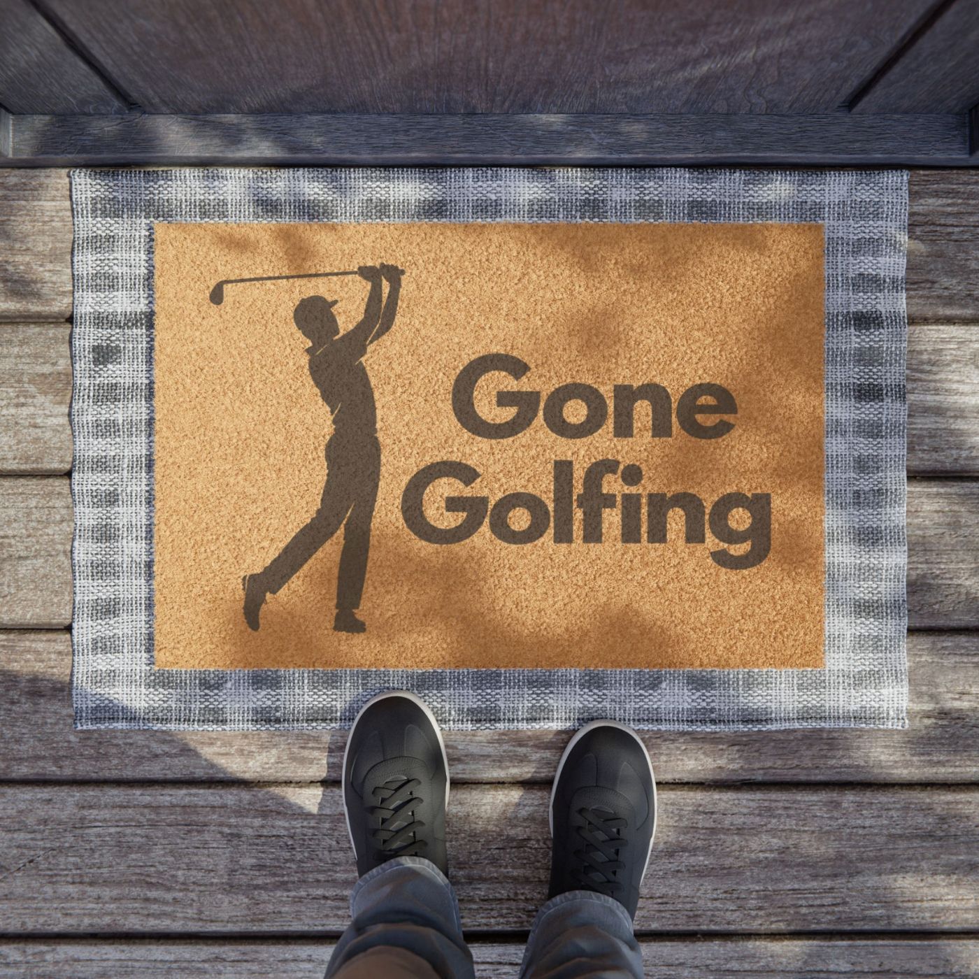 Gone Golfing doormat with golfer silhouette at a wood-plank front entryway