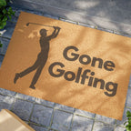 Gone Golfing coir doormat with golfer silhouette on a stone paver entryway