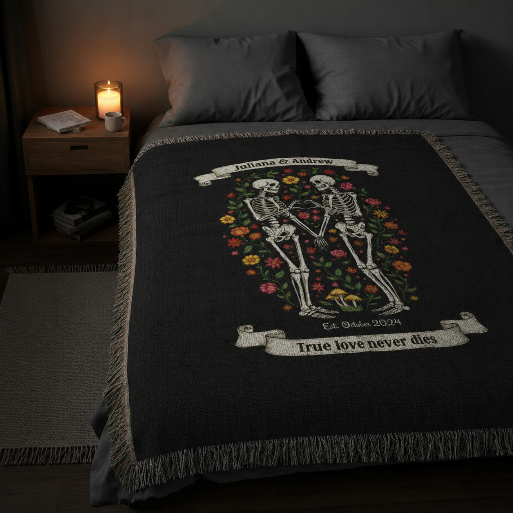 Skeleton floral woven blanket with couples names spread across bed in candlelit bedroom