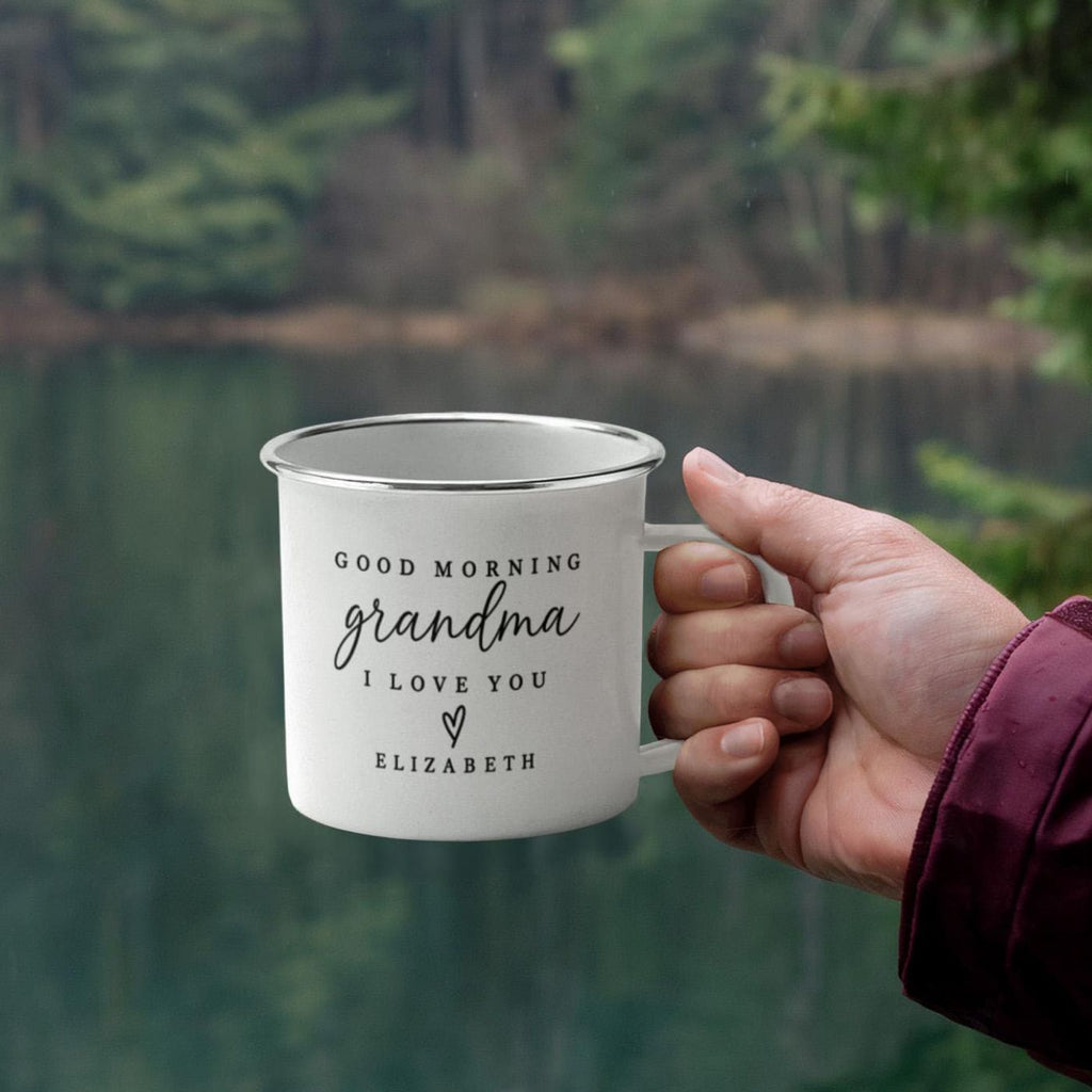 Personalized camp mug reading Good Morning Grandma I Love You Elizabeth, held lakeside
