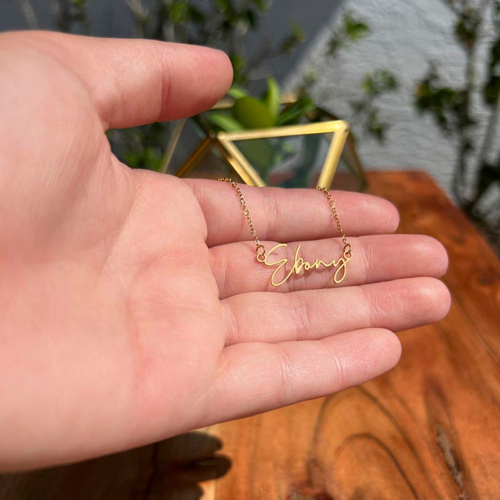 Woman wearing gold Signature Name Necklace with personalized name pendant