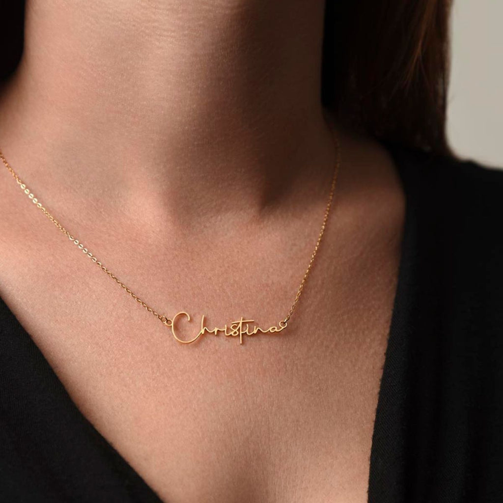 Woman wearing gold Signature Name Necklace with personalized name pendant